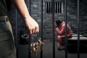Reisig Criminal Defense & DWI Law, LLC Prison guard with keys walking outside cell